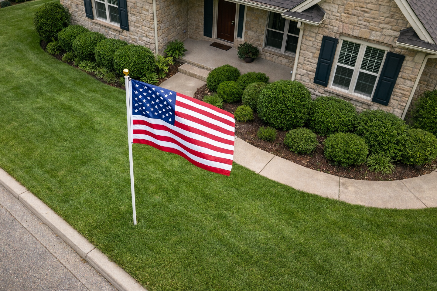 American flag on a lawn in front of a house